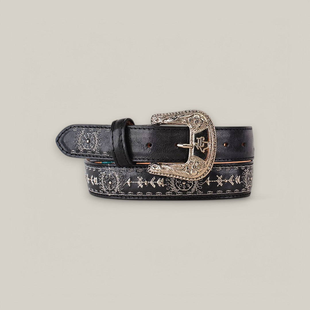 The Desert Black Belt - Texas Buckle embodies timeless elegance with its ornate silver buckle featuring intricate engravings. Decorative stitching enhances the Western-inspired design of this stylish womens belt.