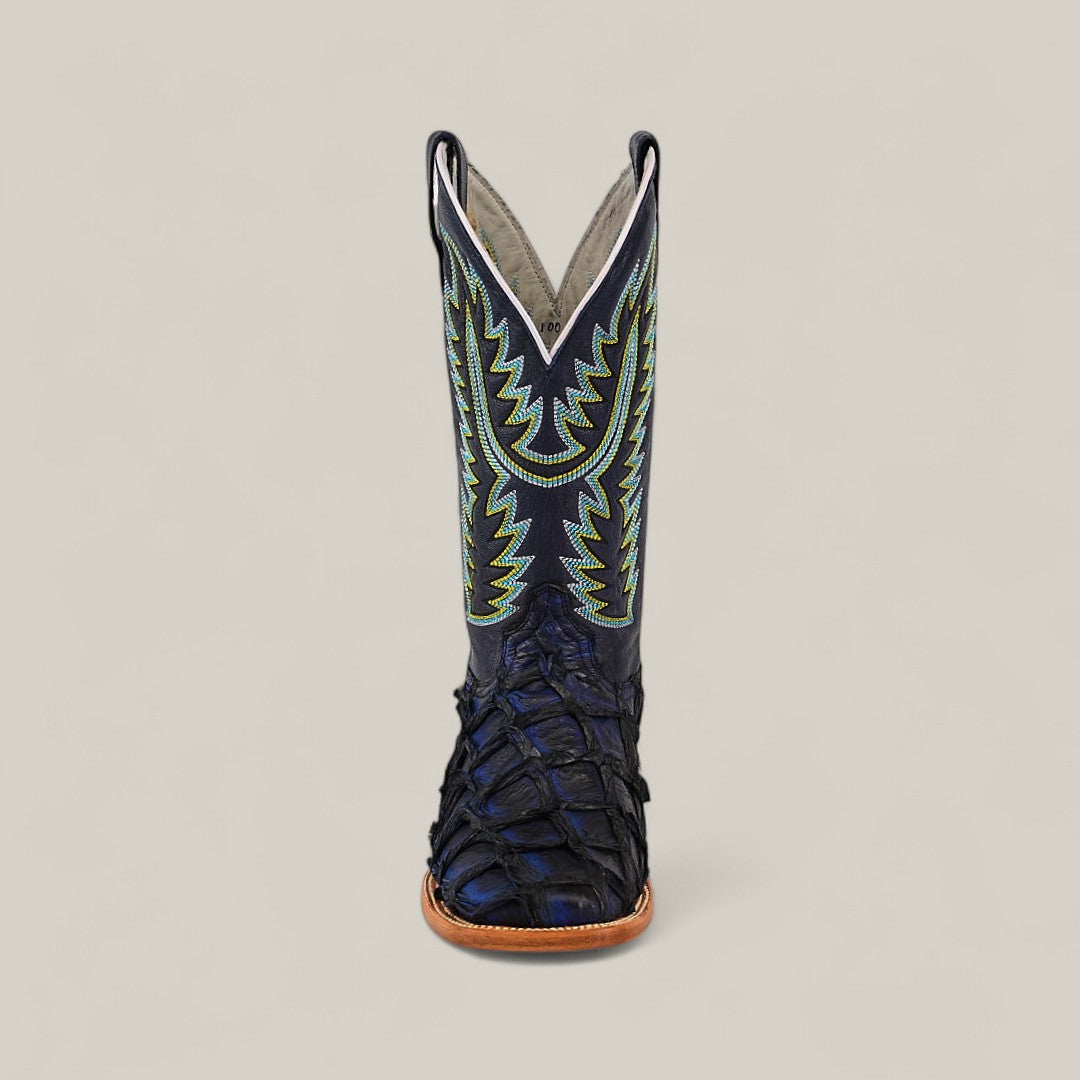 The Exotic Pirarucu Fish - Navy Black - Square Toe boot features a black, scale-textured foot and tall shaft with detailed green and blue stitching, displayed on a light background as part of the luxury Platinum Collection.