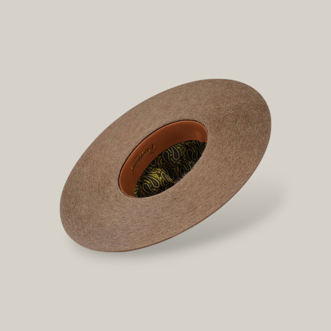 The 10X Grizzly - Tacchino is a brown, wide-brimmed felt hat with an open crown and top, featuring a patterned inner lining and leather band, displayed on a plain light background.