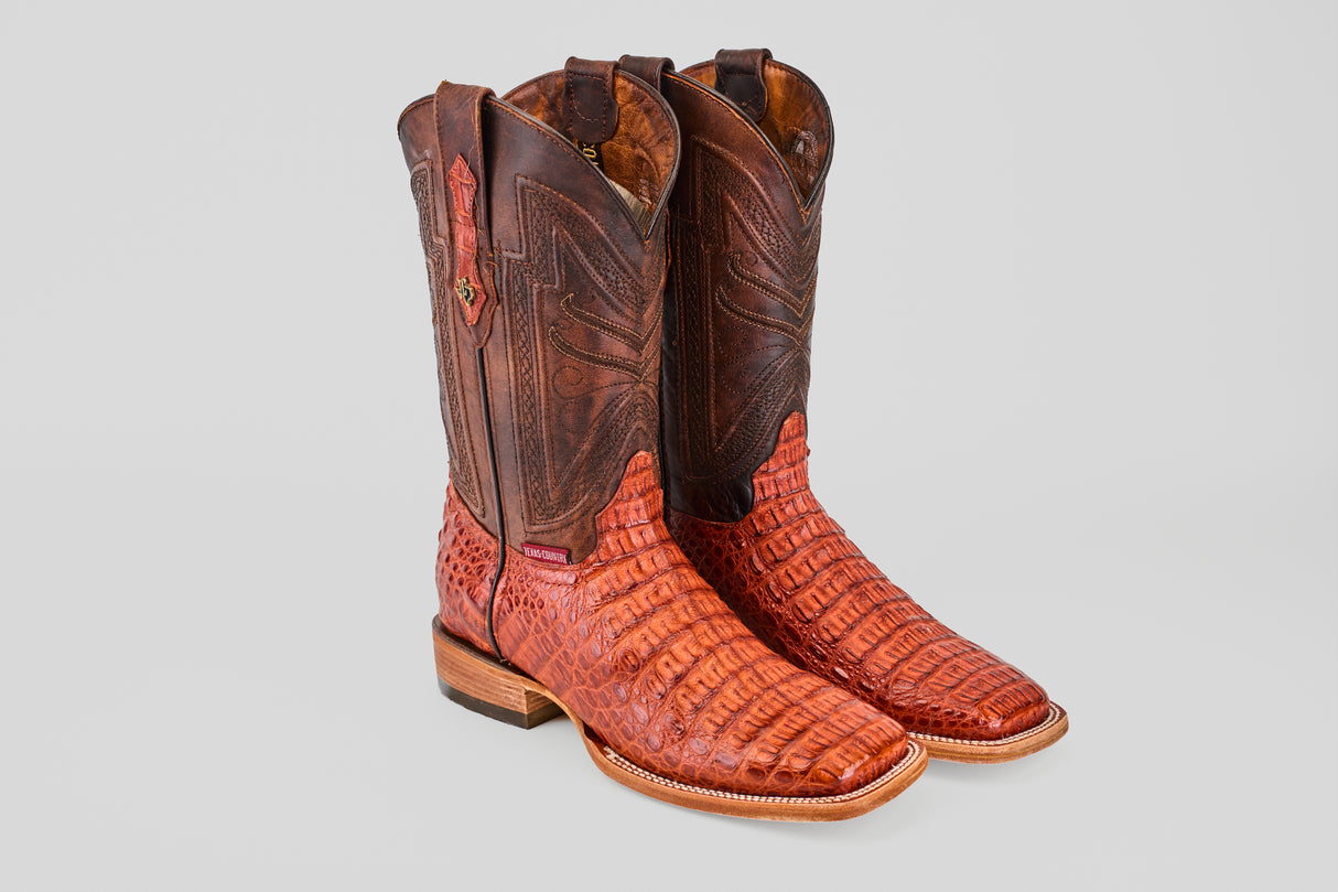 The Exotic Caiman Horn Back - Brandy - Square Toe boots feature textured reddish-brown leather on the vamp and dark brown stitched leather shafts, shown upright against a light gray background.