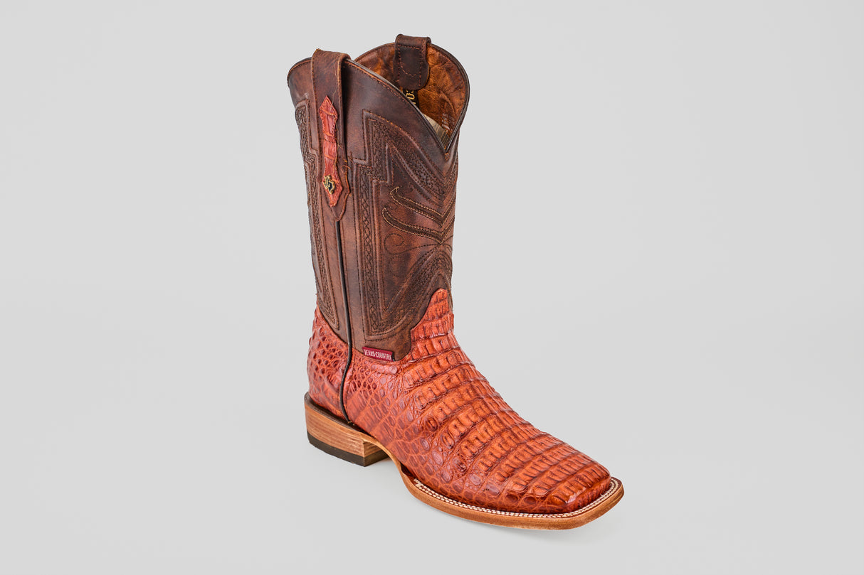 The Exotic Caiman Horn Back - Brandy - Square Toe boot features intricate stitching, a textured horn back pattern, square toe, and wooden heel, displayed singly on a plain light gray background.