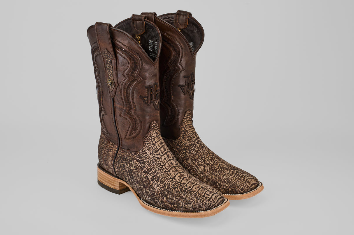 Exotic Full Quilt Ostrich Leg - Matte Orix boots feature brown, textured ostrich leg leather on the foot, a smooth dark shaft with decorative stitching, a square toe, and a light wooden heel.