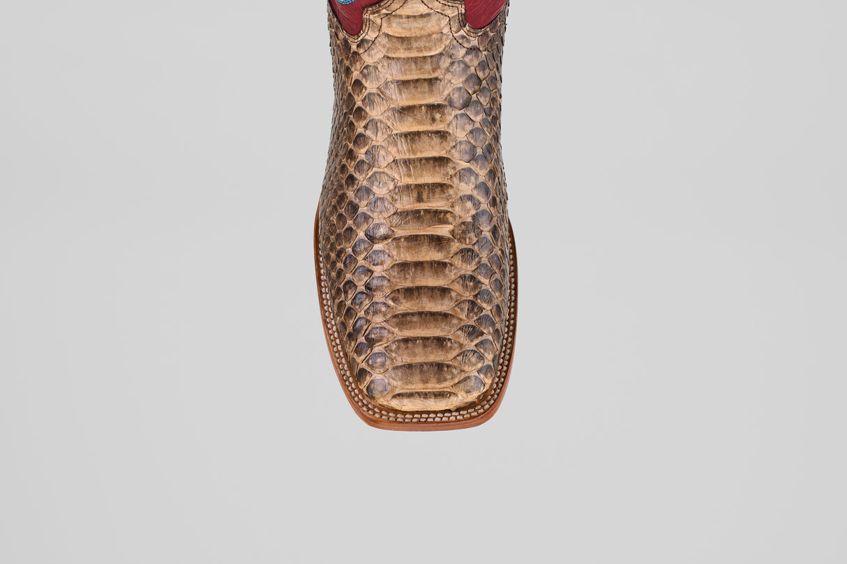 A close-up, top view of the Barlow - Taupe - Square Toe boot highlights its python leather texture, detailed scale patterns, and visible stitching—an eye-catching choice for mens statement footwear.