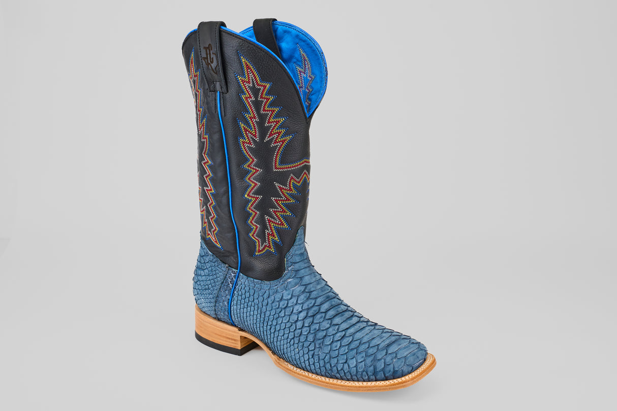 Step into standout style with Kingsley - Blue Jeans - Square Toe boots, featuring blue snakeskin, a black leather shaft with orange and white zigzag stitching, blue lining, and a light brown wooden sole – the perfect mens boots for bold fashion.