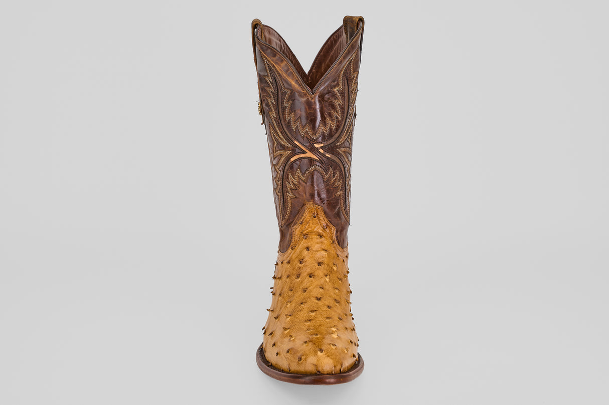 Front view of the Exotic Full Quilt Ostrich - Paja - Round Toe boot in brown, featuring detailed stitching and a textured lighter ostrich leather lower section, displaying classic Western style against a plain white background.