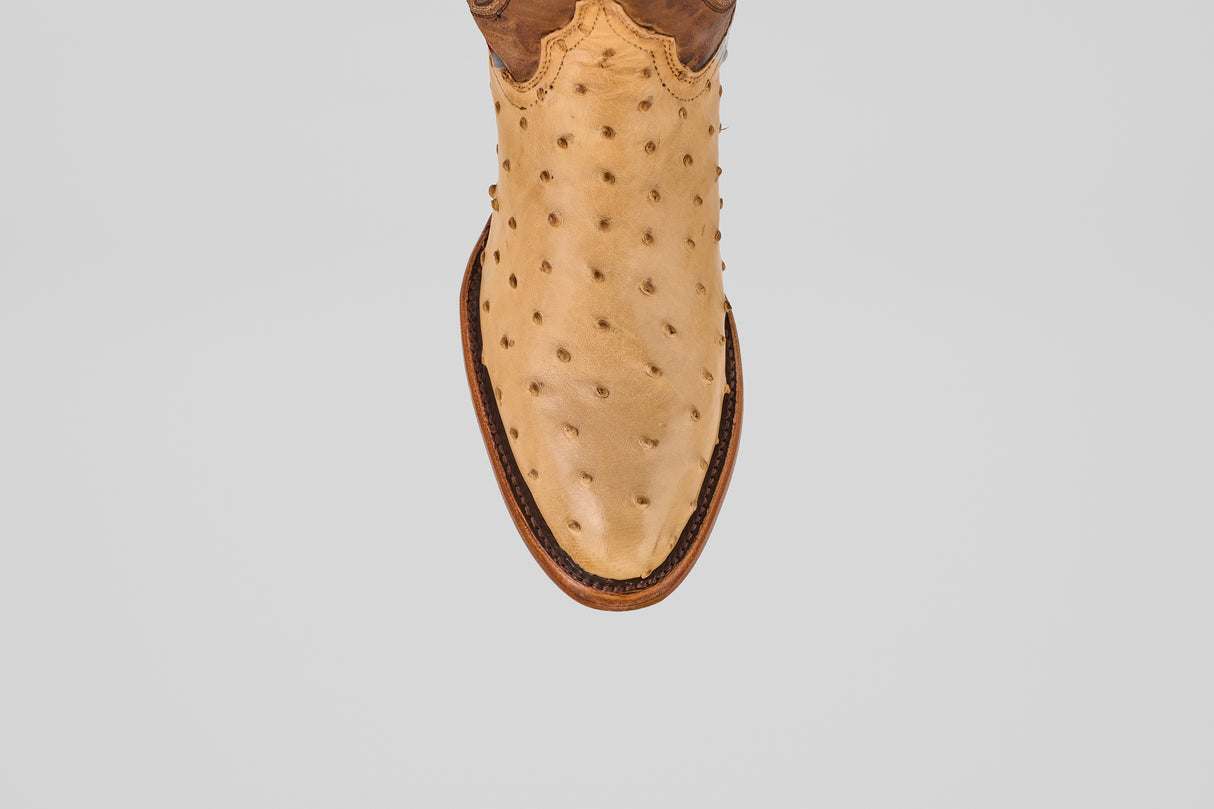 The Exotic Full Quilt Ostrich - Orix features tan ostrich leather with round toe, brown welt stitching, and full quill bumps—showcasing handcrafted Western quality. Photographed from above on a white background.