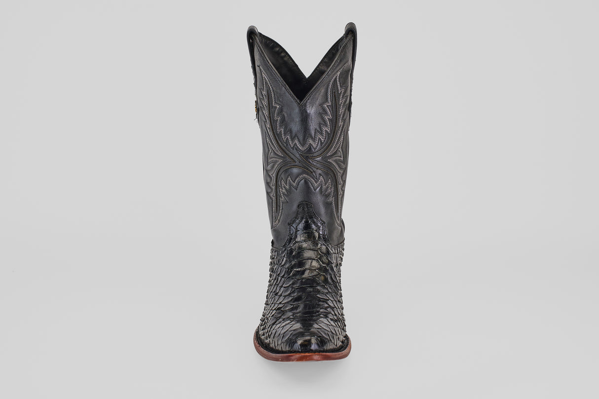 The Tanner - Black - Round Toe cowboy boot, shown front-facing on a plain light background, features intricate stitching and a textured reptile-like pattern in Python Negro Oval leather.