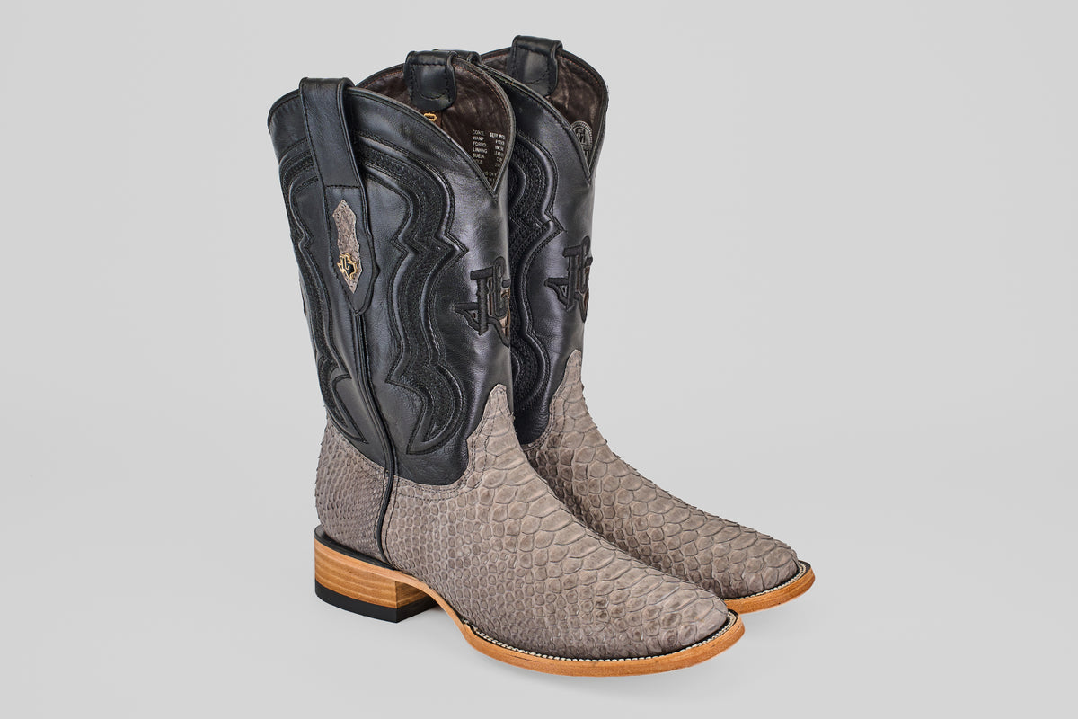 The Tanner - Matte Gray - Square Toe boots feature light tan Python Gris Nobuck snakeskin on the foot, black leather shafts with decorative stitching, wooden heels, and leather soles.