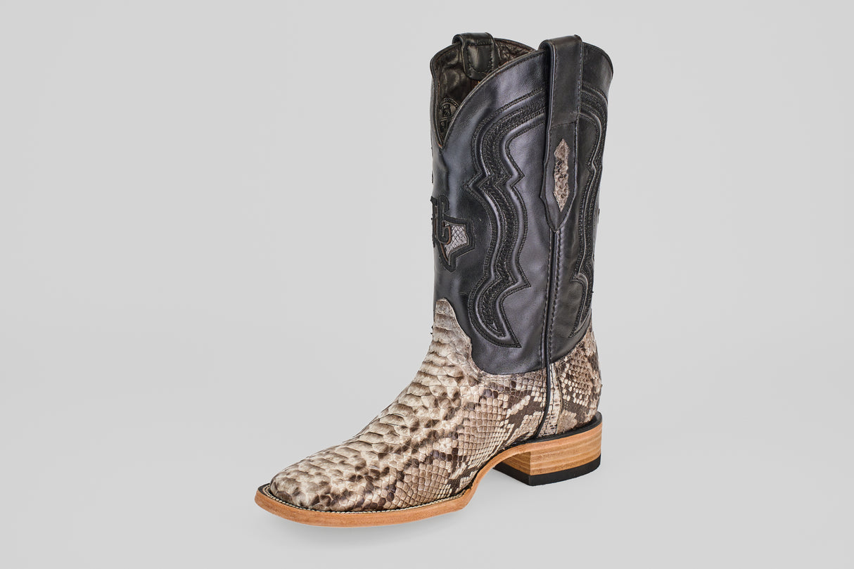The Tanner - Natural - Square Toe boot features a light brown Python Natural snakeskin lower, black leather upper with decorative stitching, and a wooden heel and sole.