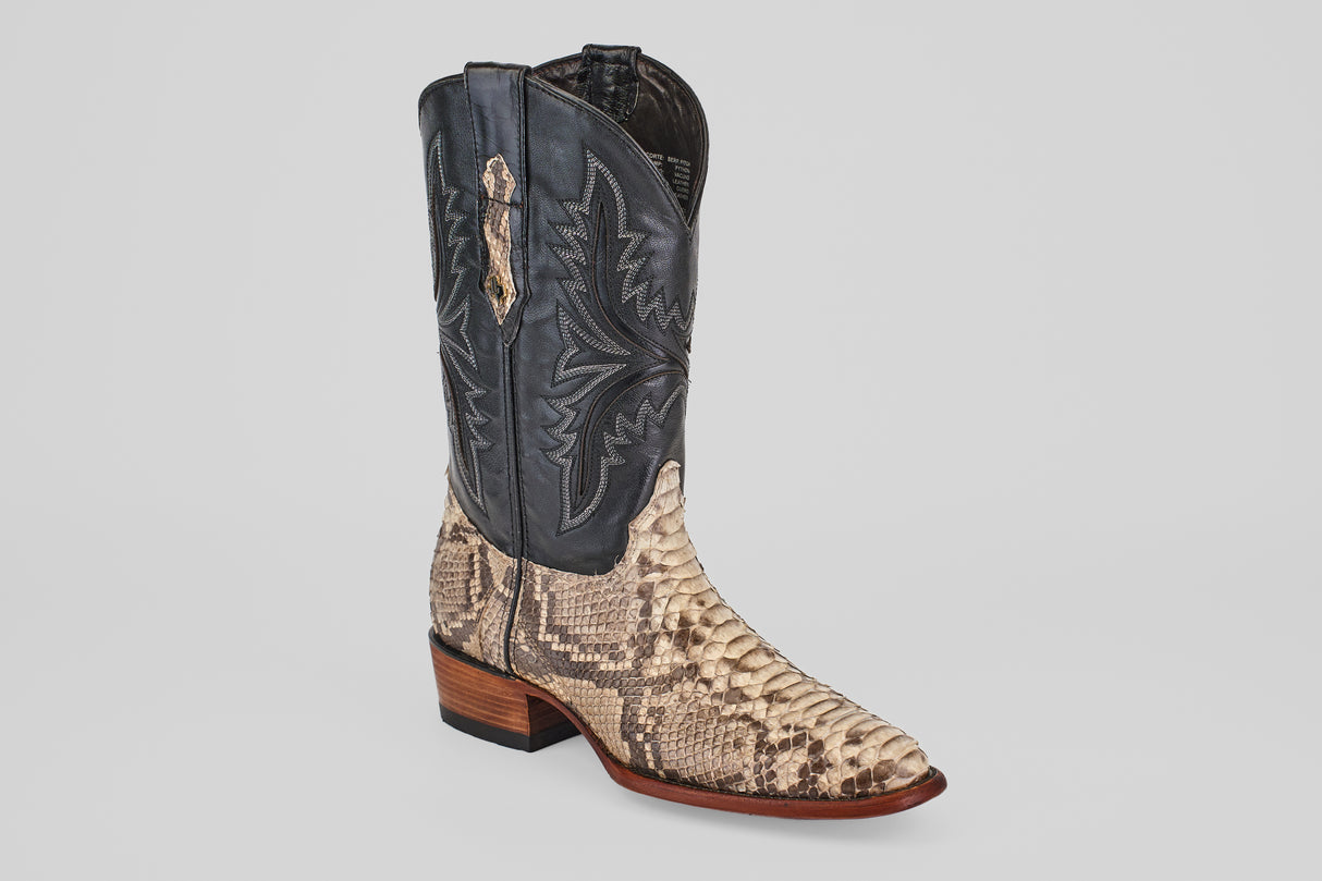 The Tanner - Natural - Roper Toe is a cowboy boot with a natural tan and brown python snakeskin lower, black leather upper with decorative stitching, low wooden heel, and pointed toe, shown on a plain light background.