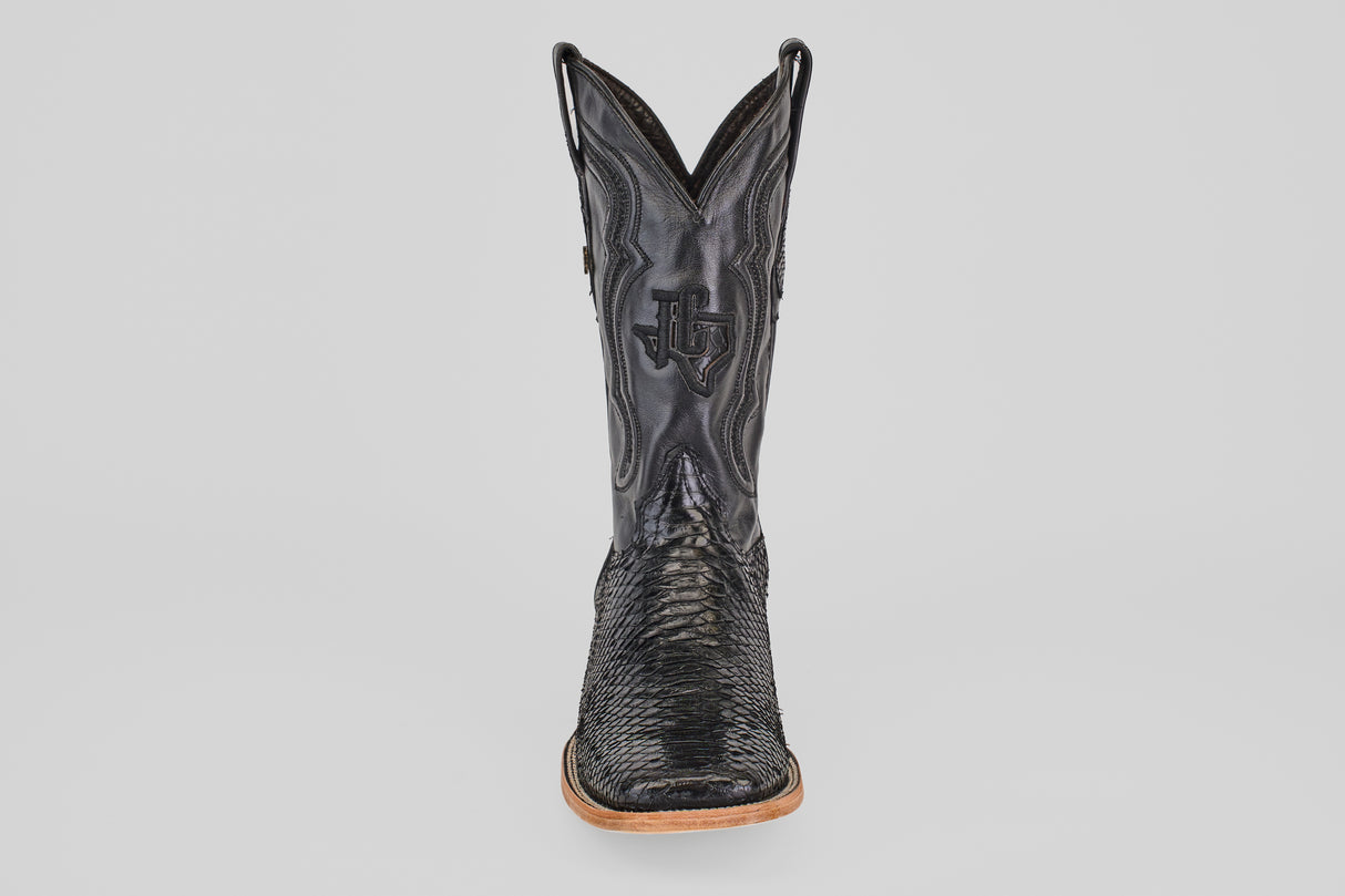 A single Tanner - Black - Square Toe cowboy boot in Python Negro leather, featuring decorative stitching and a wooden sole, is shown from the front against a plain light background.