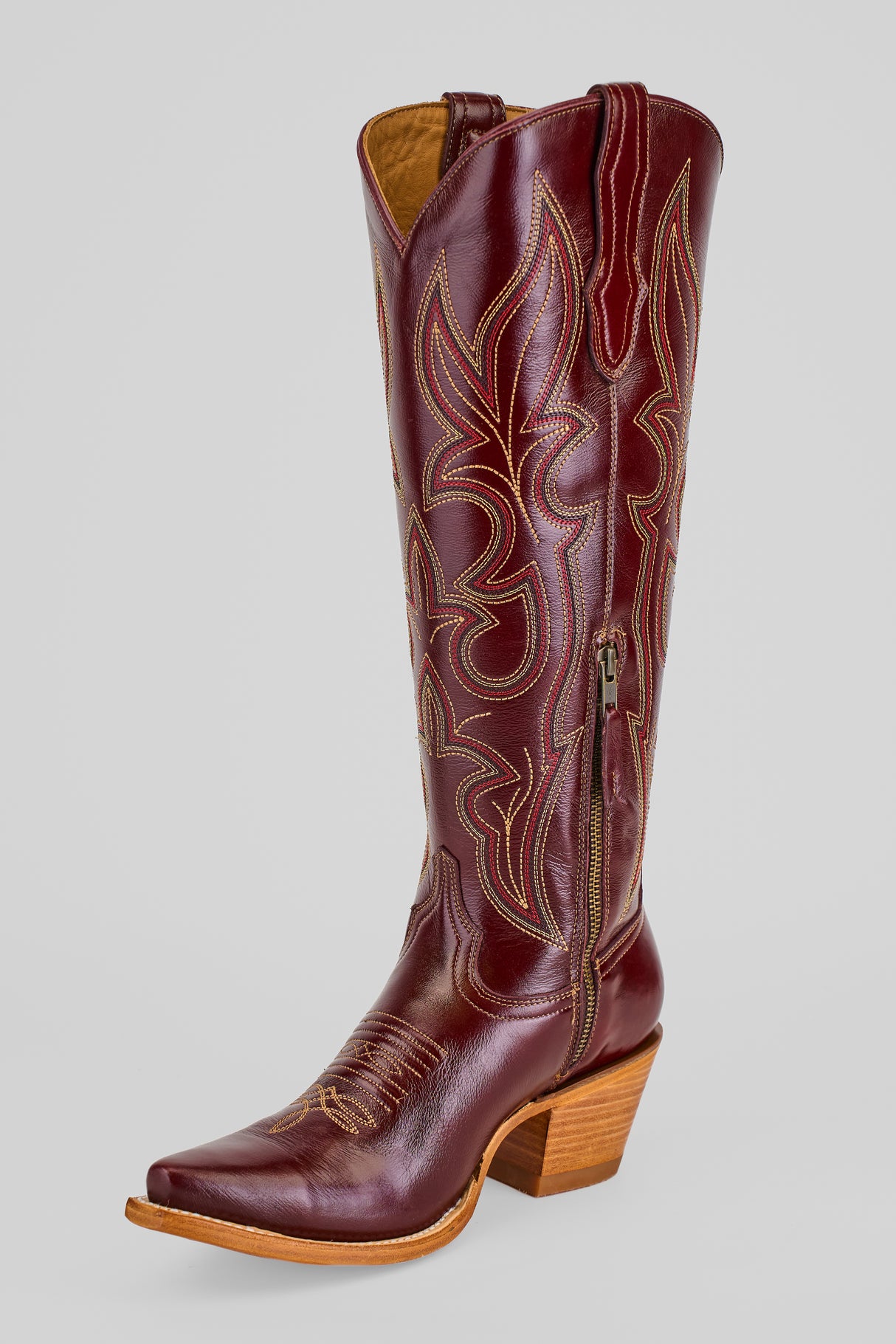 The Allison Blackberry - Tall Shaft - Snip Toe is a women's tall brown leather Western boot with decorative stitching, pointed toe, side zipper, and stacked wooden heel, shown on a plain light gray background.