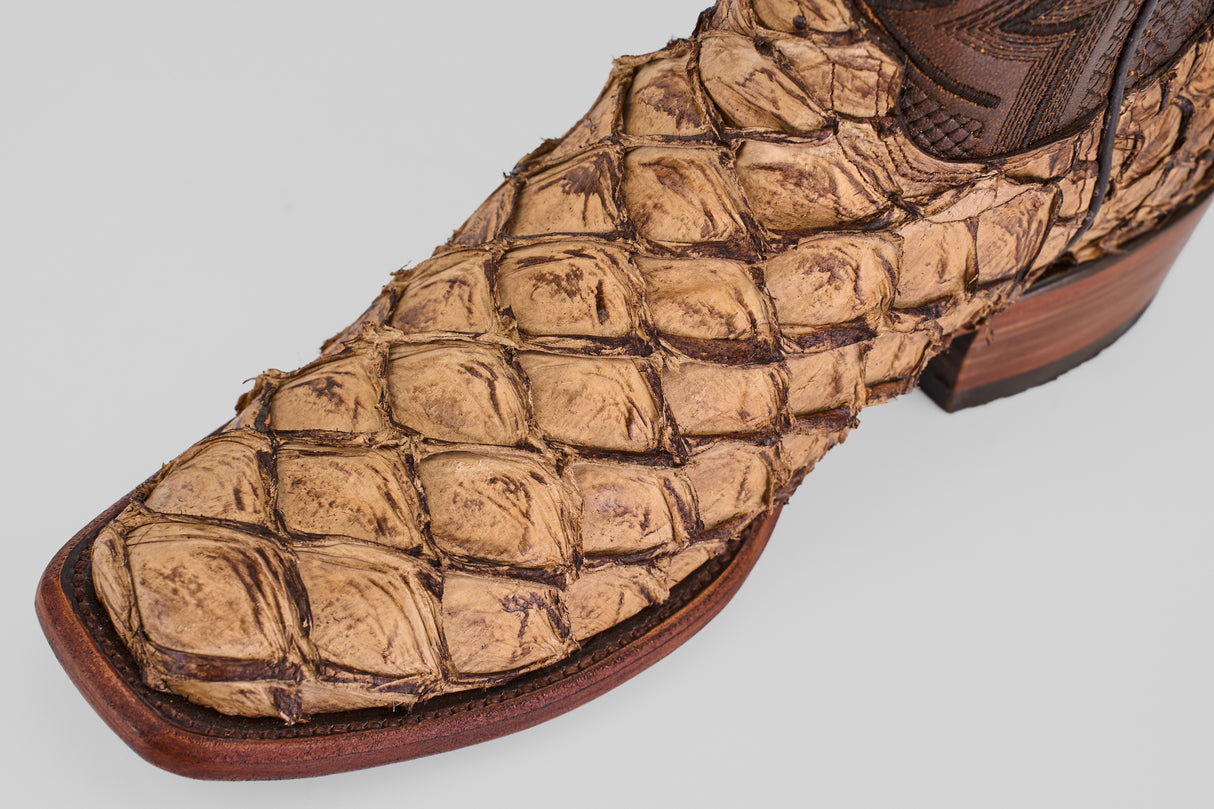 A close-up of the Conor - Matte Orix boot highlights its brown Pirarucu leather with visible scales, a refined Matte Orix finish, and a narrow square toe design.