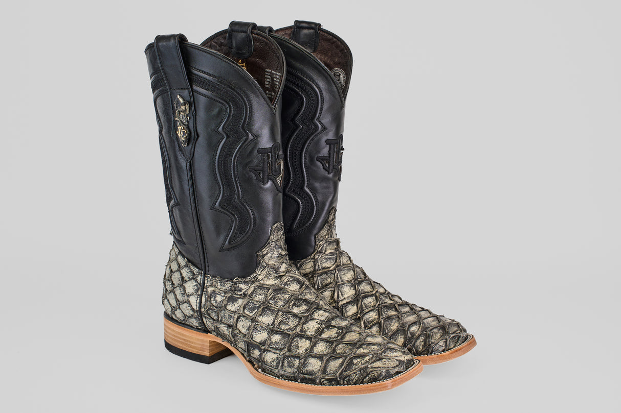 The Conor - Rustic Bone - Square Toe men's cowboy boots feature black leather uppers, rustic bone textured exotic fish leather lowers, wooden soles, and decorative stitching on the shafts.