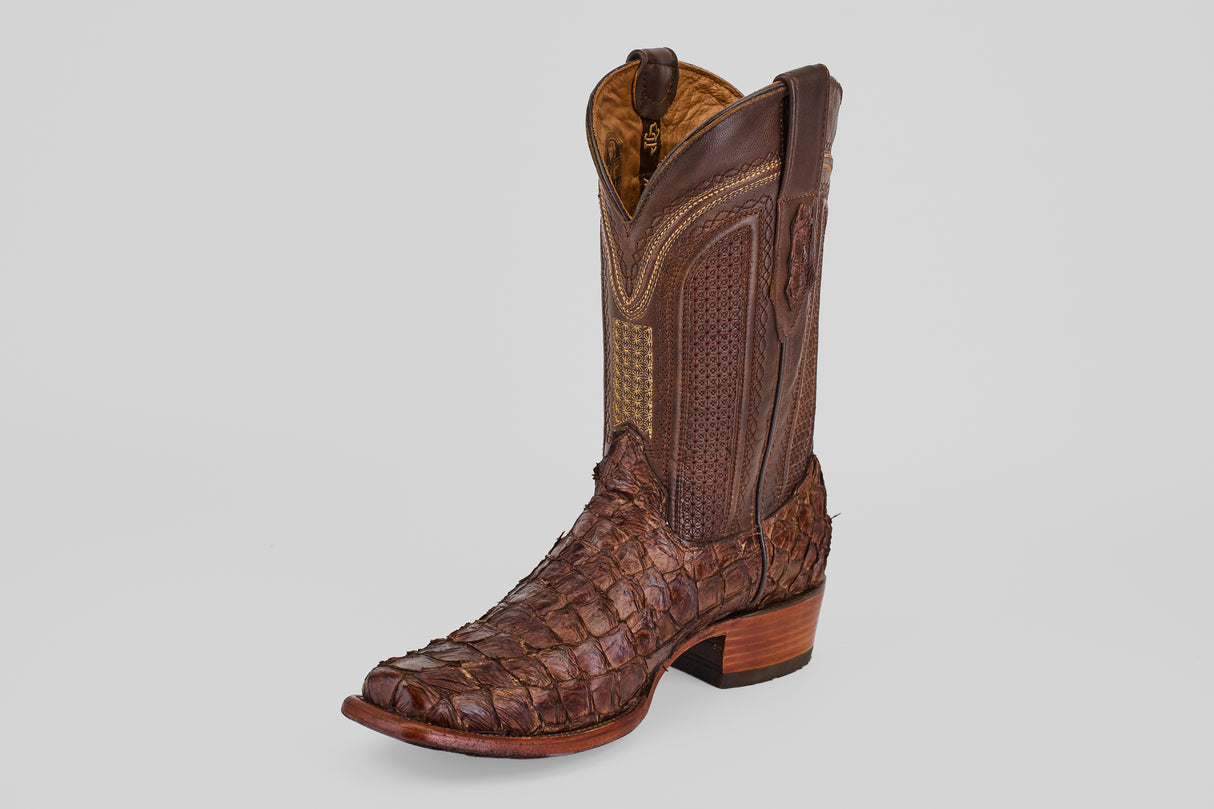 The Conor - Brown - Narrow Square Toe is a single brown high-top western boot crafted from textured leather with a scale-like pattern, intricate stitching, a narrow square toe, and stacked wooden heel.