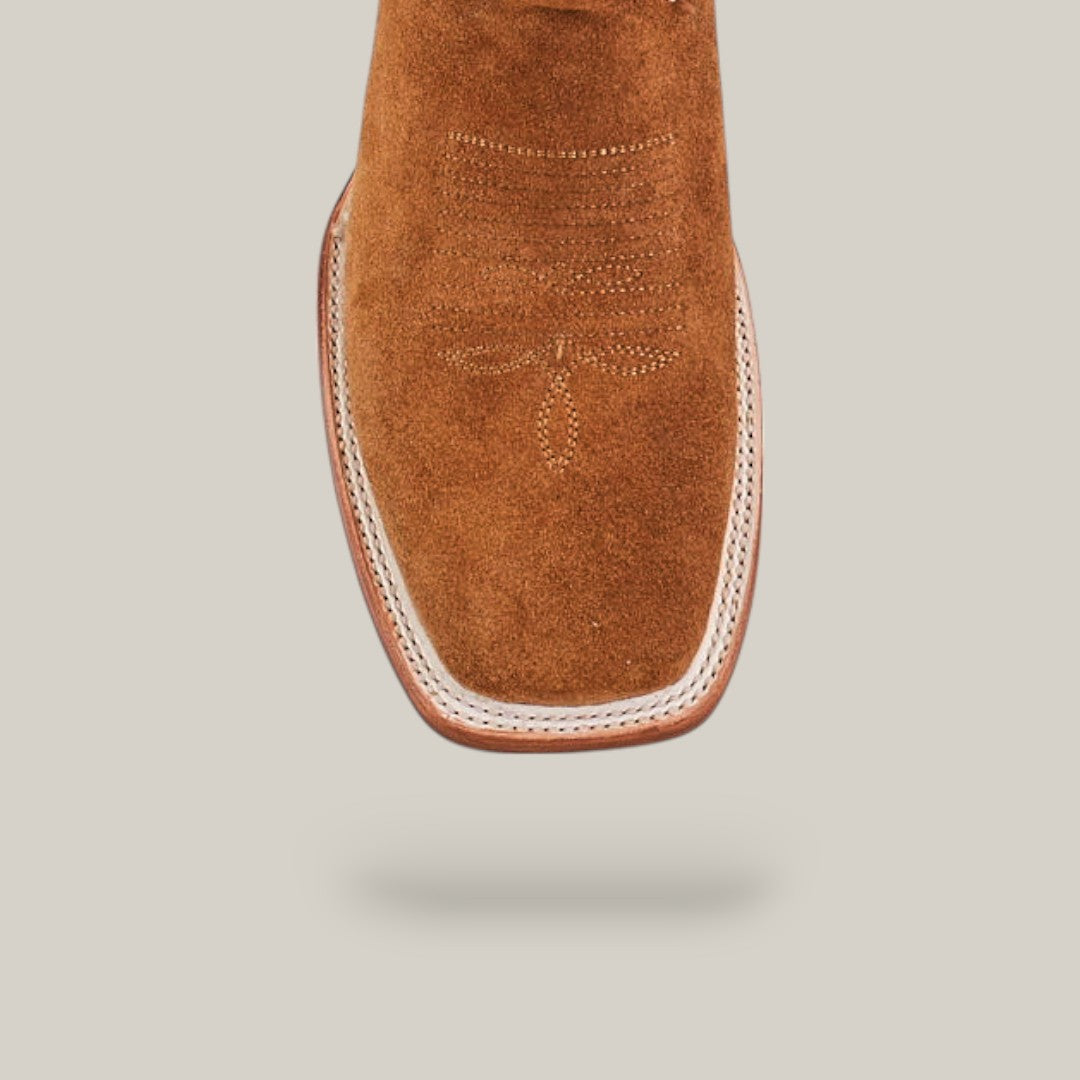 Close-up of the toe of the Bronson - Gold - Square Toe mens boot in brown suede, featuring decorative stitching and a square leather sole, set against a plain light background.