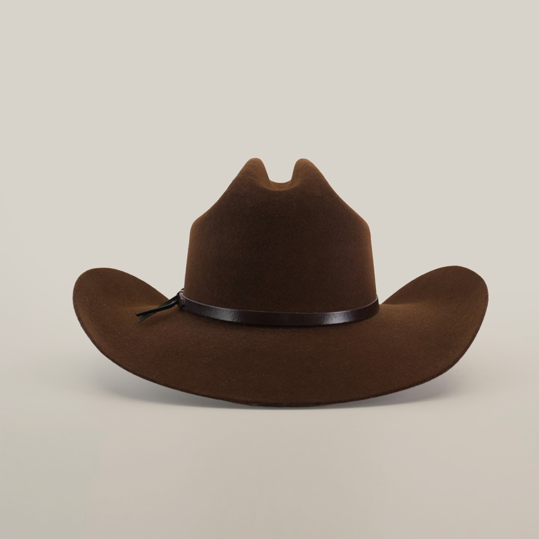 A 6X Dallas Brown felt cowboy hat with a wide brim and black band rests against a white background. It features a crown crease, exuding Western sophistication typical of cowboy hats.