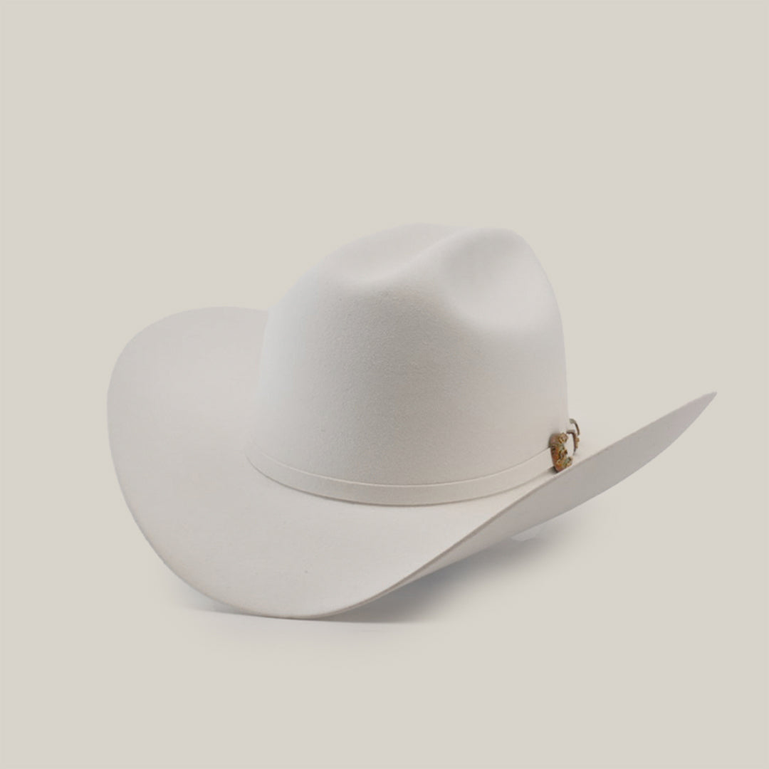 The 1000X Imperial White, a white Western hat with a wide brim and decorative band, exudes classic style and charm against a plain light background.