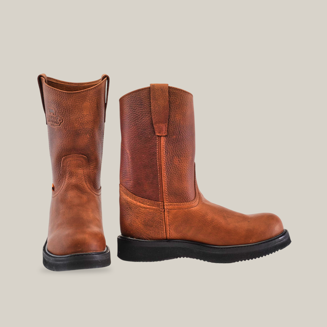 A pair of brown leather Brandy Roper boots with Laredo soles, crafted from premium cowhide leather, is displayed against a white background; one boot stands upright while the other tilts slightly, highlighting Western bootmaking heritage.