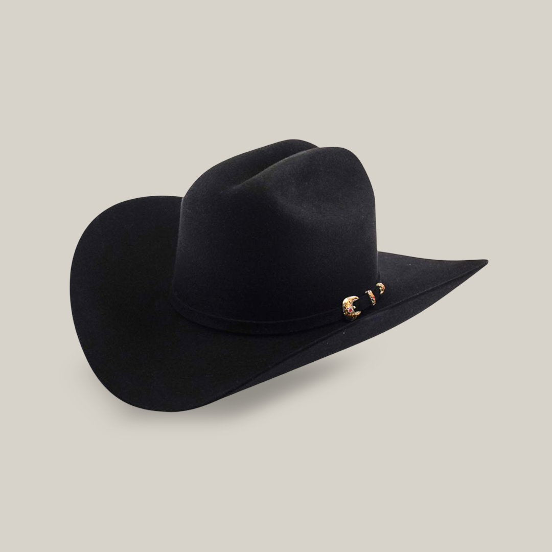 A black cowboy hat with a wide brim and decorative gold accents on the band, set against a plain gray background.