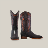 Exotic Stingray - Herradura boots in black feature intricately designed handcrafted leather with woven patterns, studded details, and an exotic herradura. These square-toe boots have a slight heel and are displayed to highlight both front and side views.