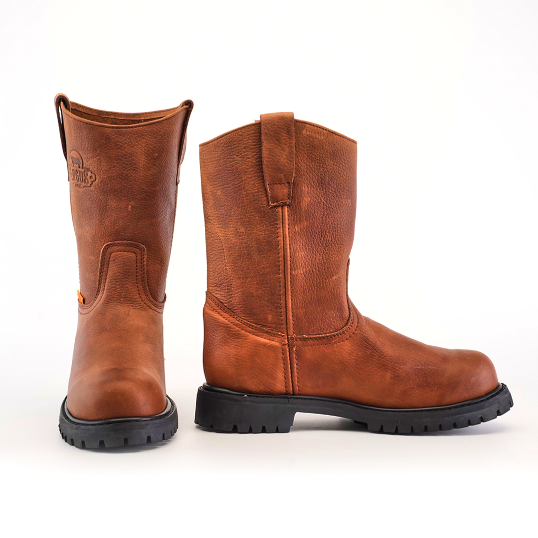 The Brandy Roper boots feature handcrafted premium cowhide leather with black rubber tractor soles, showcasing one upright brown leather cowboy boot alongside another that is slightly angled against a plain white background.