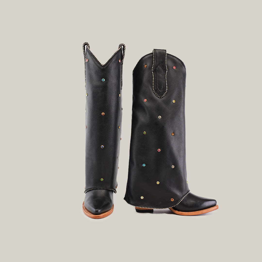 The Roma Rainbow Crystals Tall Shaft Black - J Toe cowboy boots are handcrafted treasures in black leather with colorful studs and decorative stitching. They feature a wooden sole and pointed toe, showcased against a plain white background.