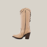 The Praga Fringe Tall Shaft Cream - J Toe is a handcrafted knee-high boot in tan with decorative studs, a side zipper, chunky heel, and crisscross lacing on the back. Part of our Platinum Collection, it is set against a plain white background.