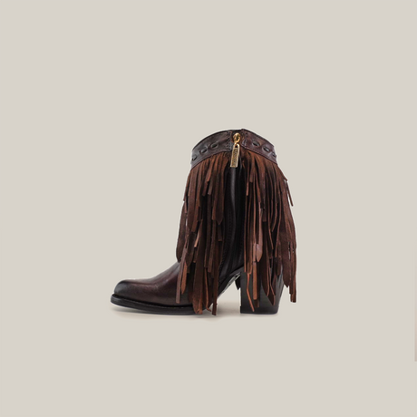 The Austin Fringe Bootie Chocolate J Toe is a brown leather ankle boot, featuring premium leather, fringe details, a block heel, and zipper closure on a white background.