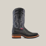 The Lizard Print Black cowboy boot boasts an intricate embroidered shaft design, pull tab, and stacked wooden heel. Made from premium cowhide leather, it features a slip-resistant sole with a contrasting brown heel and sole, accented by a red and white label near the ankle.