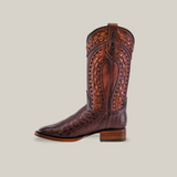 The Exotic American Alligator - Herradura - Tabaco boot, crafted from brown leather with intricate stitching and embossed textures, epitomizes classic Western footwear. It showcases a square toe, mid-calf height, and a small stacked heel against a light gray background.