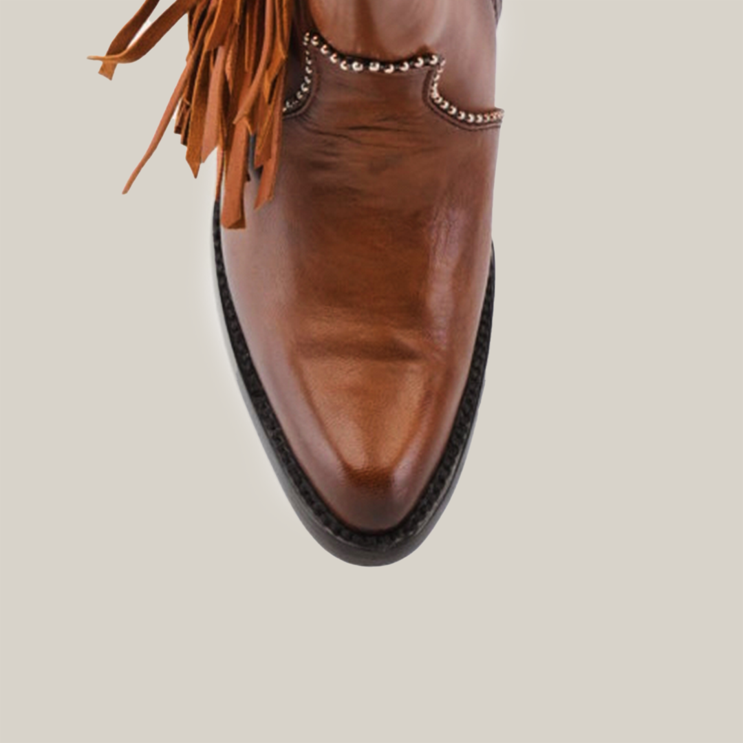 Close-up of a Praga Fringe Tall Shaft Tan - J Toe cowboy boot from the Platinum Collection, crafted in high-quality leather with decorative fringe and silver detailing, set against a plain white background.