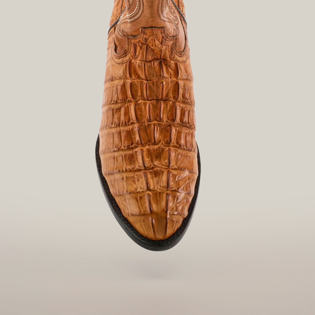 Close-up of the Crocodile Tail Print Buttercup - Round Toe boot made from premium cowhide leather with a crocodile tail print, intricate stitching near the top, and a genuine leather sole, set against a plain white background.