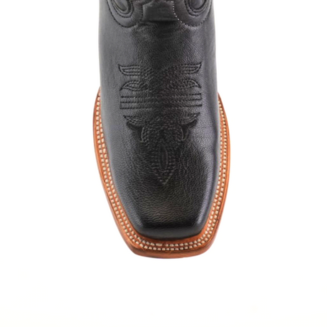 Close-up of a Western Stitch Black Lustre boot, highlighting intricate toe stitching. Made from premium leather, it features a narrow square toe and brown sole with white edge stitching, set against a plain white background.