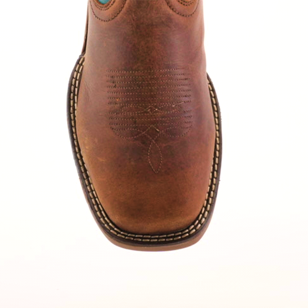 Close-up of the handcrafted Rustic Turquoise Brown boot featuring decorative stitching. It showcases a square toe and stitched welt, highlighting detailed craftsmanship with premium cowhide leather, set against a plain background.