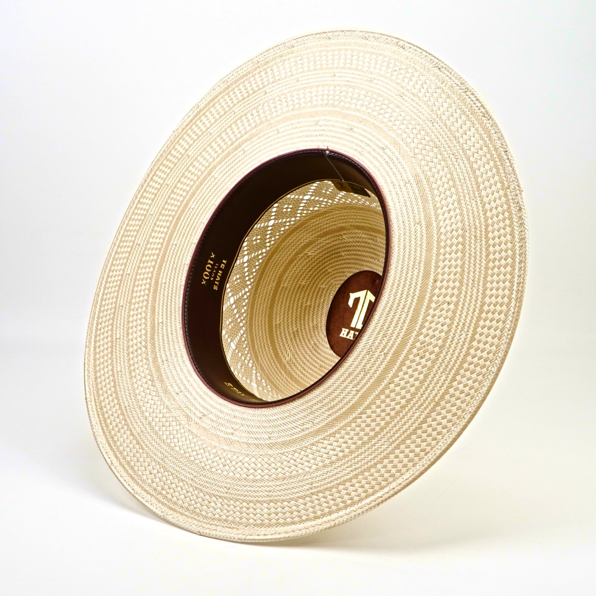 Beige straw hat with a brand logo on a white background