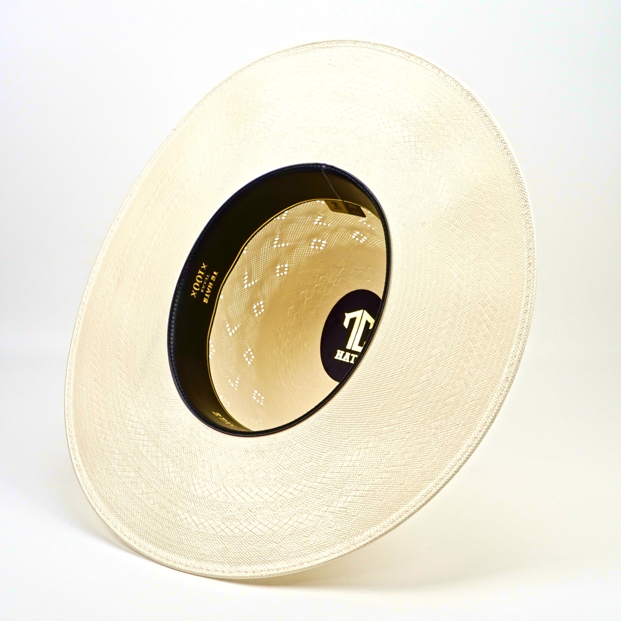 Beige straw hat with a brand logo on a white background