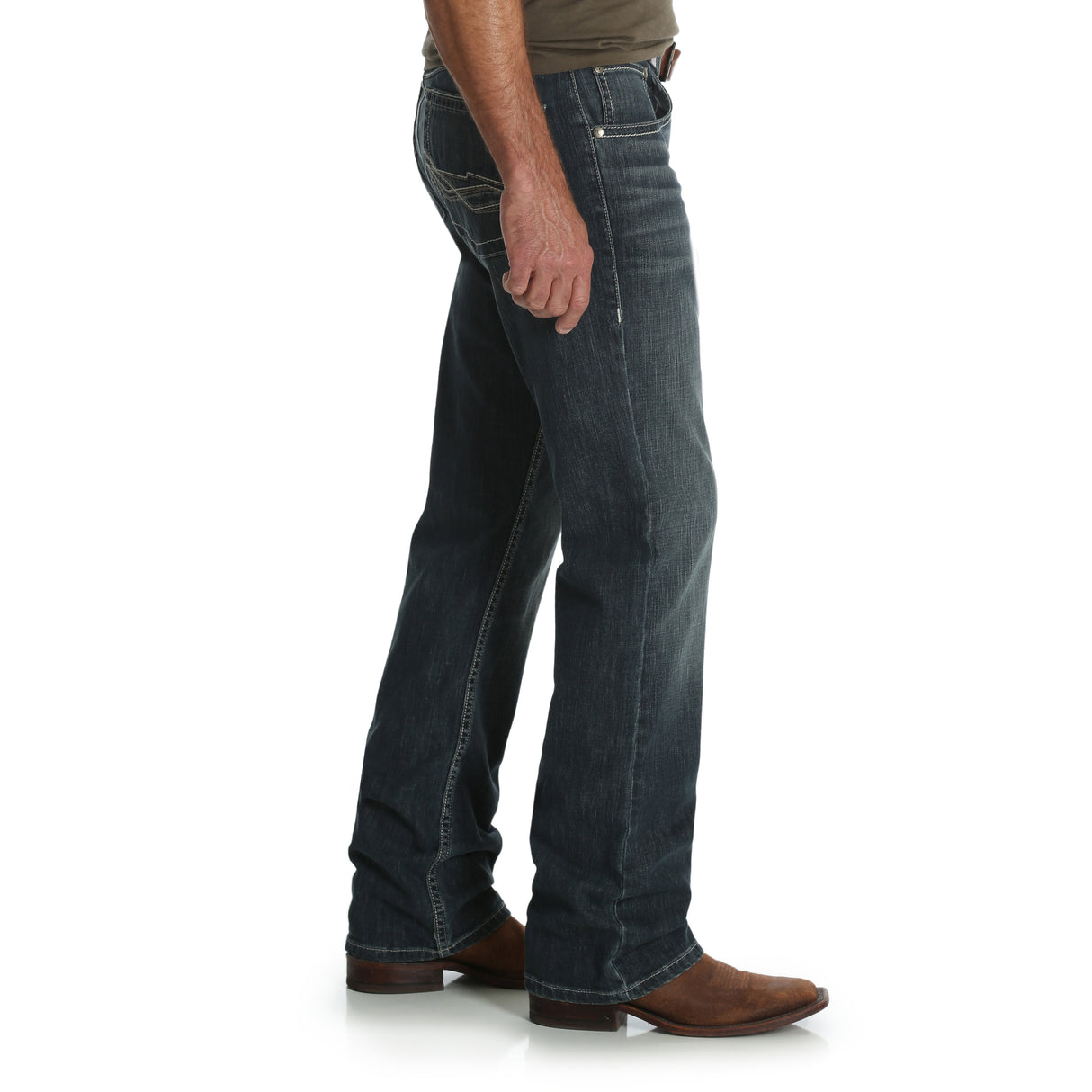 Wearing Mens Wrangler 20X No. 42 Vintage Bootcut Jeans - 42MWXGG with visible stitching and brown leather boots, a person stands in profile against a plain white background, embodying timeless style.