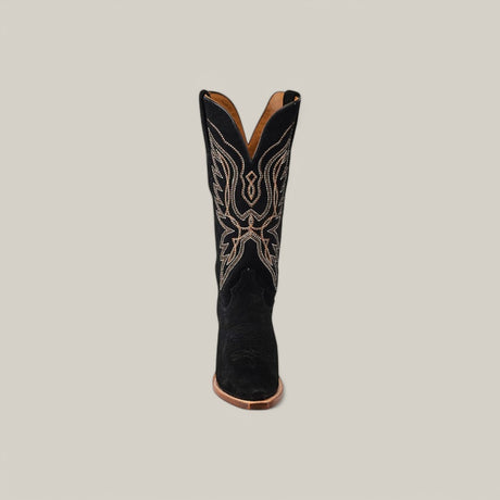 The Miranda Suede Boot is a black cowboy boot with white abstract embroidery on the shaft, featuring a snip toe design and copper sole, set against a plain gray background.