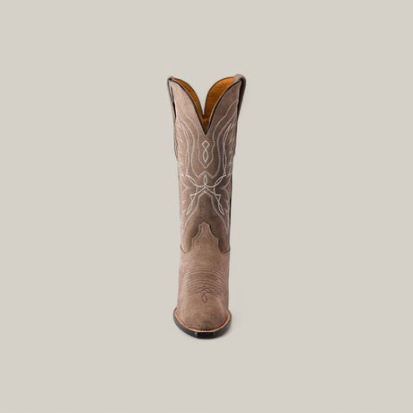 The Miranda Suede Gray Lether Sole boot features premium suede with intricate white stitching on a light gray background. This snip-toe design has a pointed toe and mid-height shaft, adorned with decorative patterns.