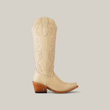 The Kellie Bone Leather Sole boot showcases a side profile view with a tan color, intricate stitching along the tall shaft, a snip toe design, and a wooden block heel against a plain light gray backdrop.