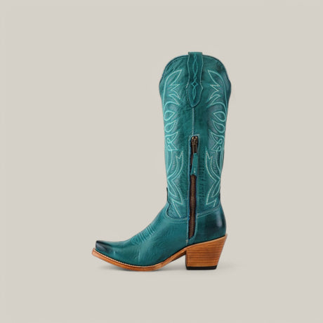 A Kellie Turquoise Leather Sole cowboy boot with intricate stitching, side zipper, snip toe, and sturdy block heel is displayed against a light gray background.