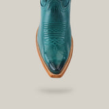 Kellie Turquoise Leather Sole boot features a tall shaft and detailed snip toe stitching, paired with a brown wooden sole, set against a light grey background.