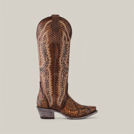 The Athala Exotic Python Tamarindo boots feature premium python leather, intricate stitching, a snip toe, and a stacked heel set against a plain light gray background, celebrating Western heritage.