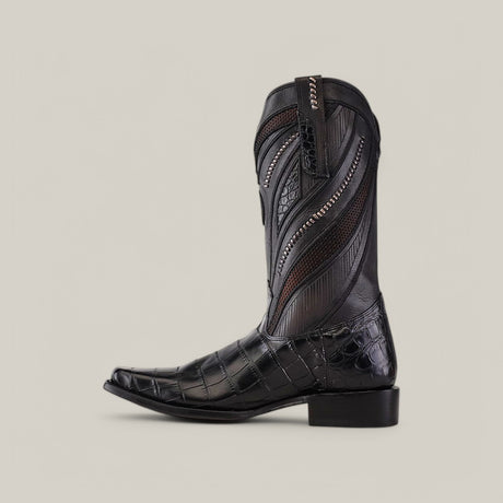 The Cuadra Boots IMPERIO model features intricate stitching and embossed patterns on its black leather cowboy boot shaft. It has a narrow square toe, stacked heel, and an Alligator Belly Black finish against a plain beige background.