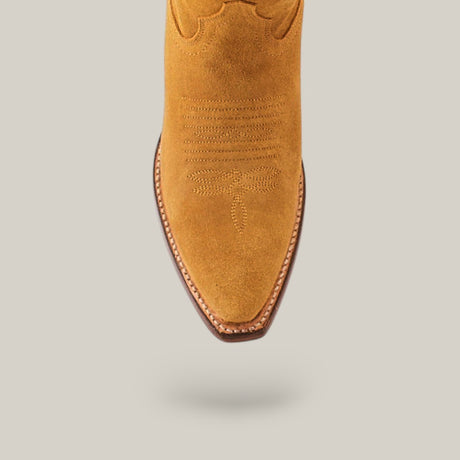 Close-up of the Miranda Suede Mid Shaft boot showcasing its intricate toe stitching and gold leather sole on a light gray background, featuring a snip toe and detailed embroidery.