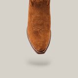 The Miranda Suede Caramel Leather Sole boot features luxury craftsmanship with decorative stitching and a snip toe, highlighted in a top view against a light gray background.