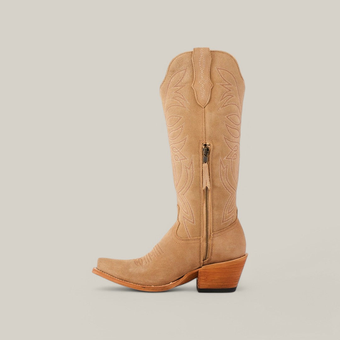 Discover the Kellie Suede Fawn boots: tan cowboy boots with mid-height wooden heels, side zippers, and intricate embroidery on a light beige shaft. Designed with snip toes and premium leather soles for lasting elegance.