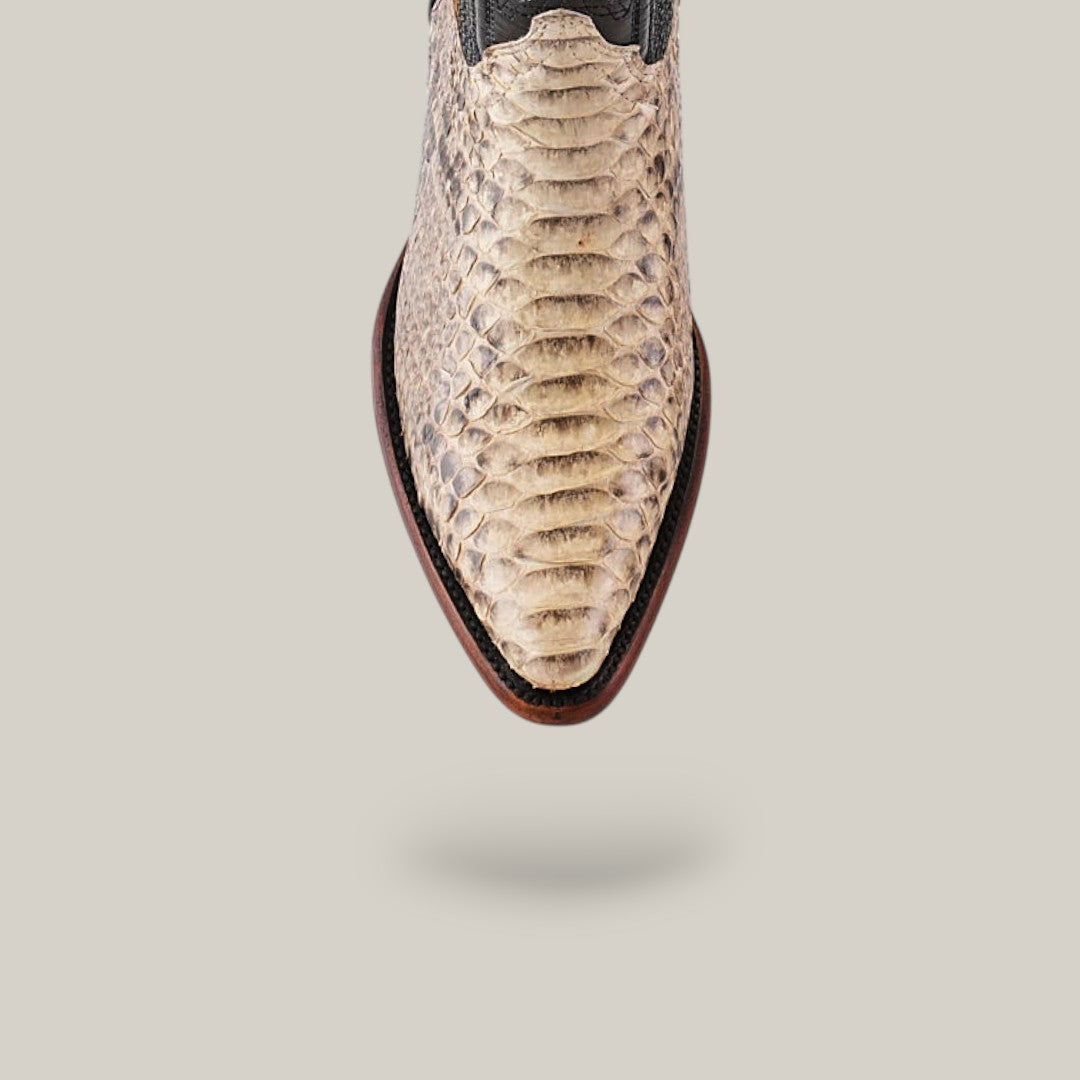 Close-up of Exotic Python - Natural - Snip Toe, featuring genuine python leather with a textured, light-hued snakeskin pattern. A shadow gently falls across the neutral background, adding to its elegance.