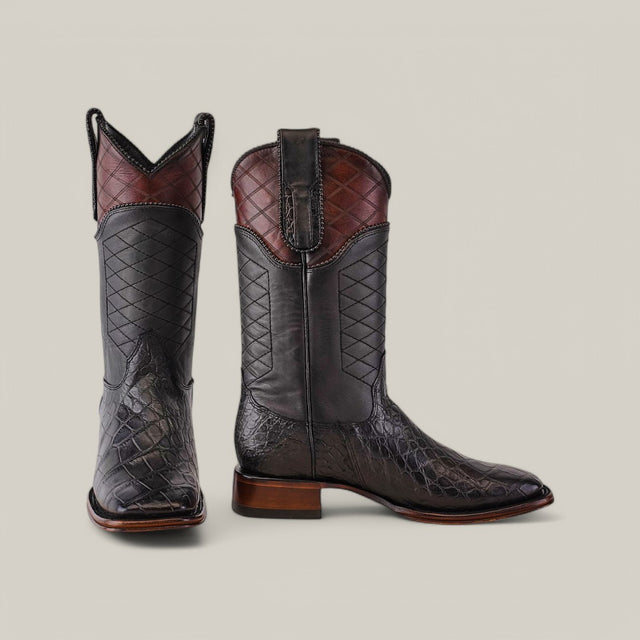 The Exotic American Alligator boots feature a stylish square toe with dark gray crocodile-textured leather, a brown top, and a stacked heel, showcasing exceptional craftsmanship.